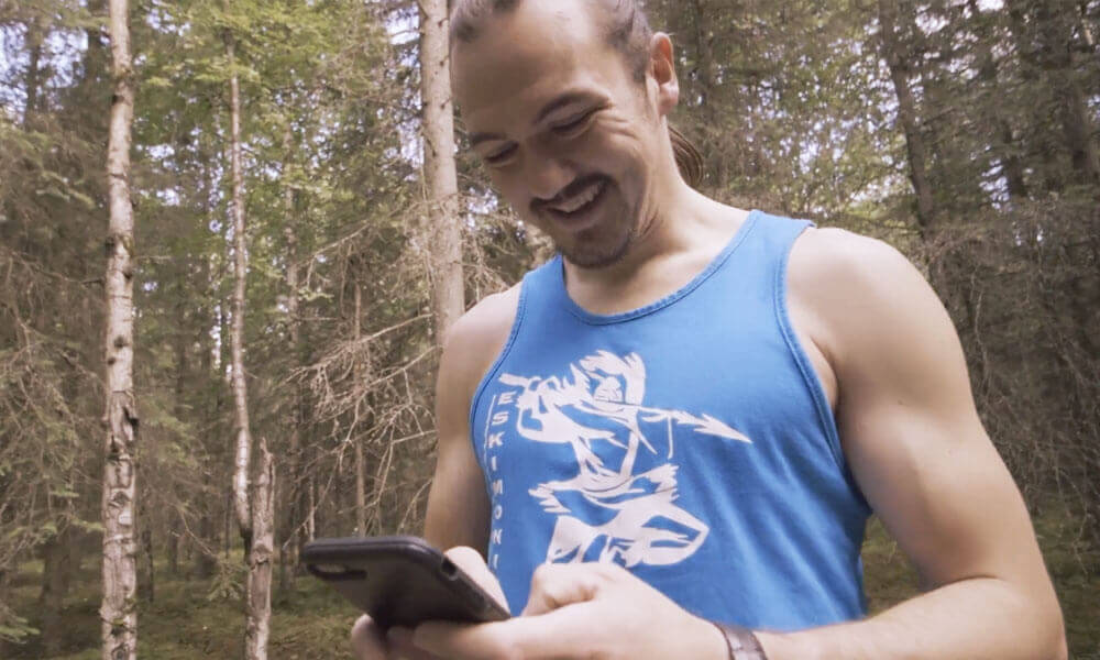 Nick Hanson Motivational Speaker on a GCI mobile device in the woods
